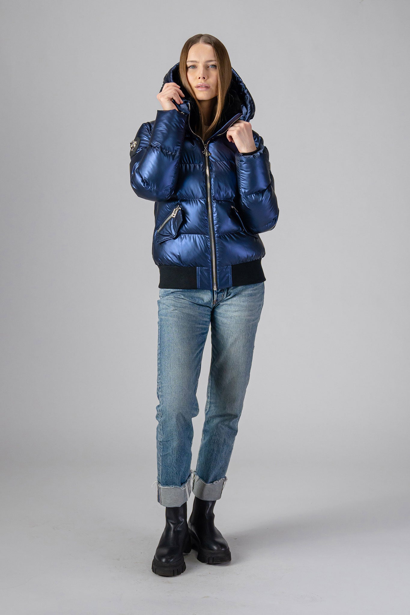 Woodpecker Women's Woody Bomber Winter coat. High-end Canadian designer winter coat for women in "Sapphire" colour. Woodpecker cruelty-free winter coat designed in Canada. Women's heavy weight short length premium designer jacket for winter. Superior quality warm winter coat for women. Moose Knuckles, Canada Goose, Mackage, Montcler, Will Poho, Willbird, Nic Bayley. Shiny parka. Stylish winter jacket. Designer winter coat.