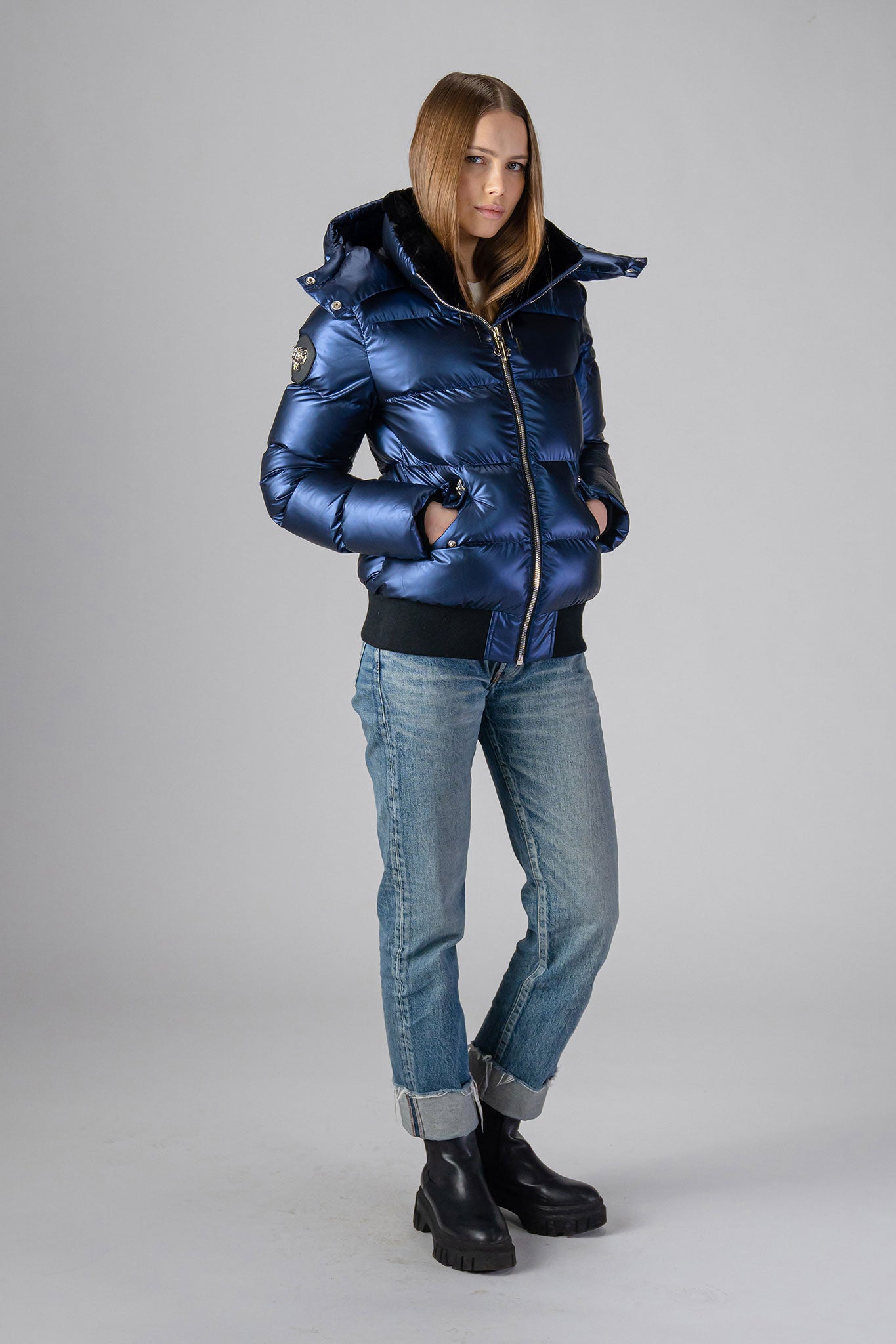 Woodpecker Women's Woody Bomber Winter coat. High-end Canadian designer winter coat for women in "Sapphire" colour. Woodpecker cruelty-free winter coat designed in Canada. Women's heavy weight short length premium designer jacket for winter. Superior quality warm winter coat for women. Moose Knuckles, Canada Goose, Mackage, Montcler, Will Poho, Willbird, Nic Bayley. Shiny parka. Stylish winter jacket. Designer winter coat.