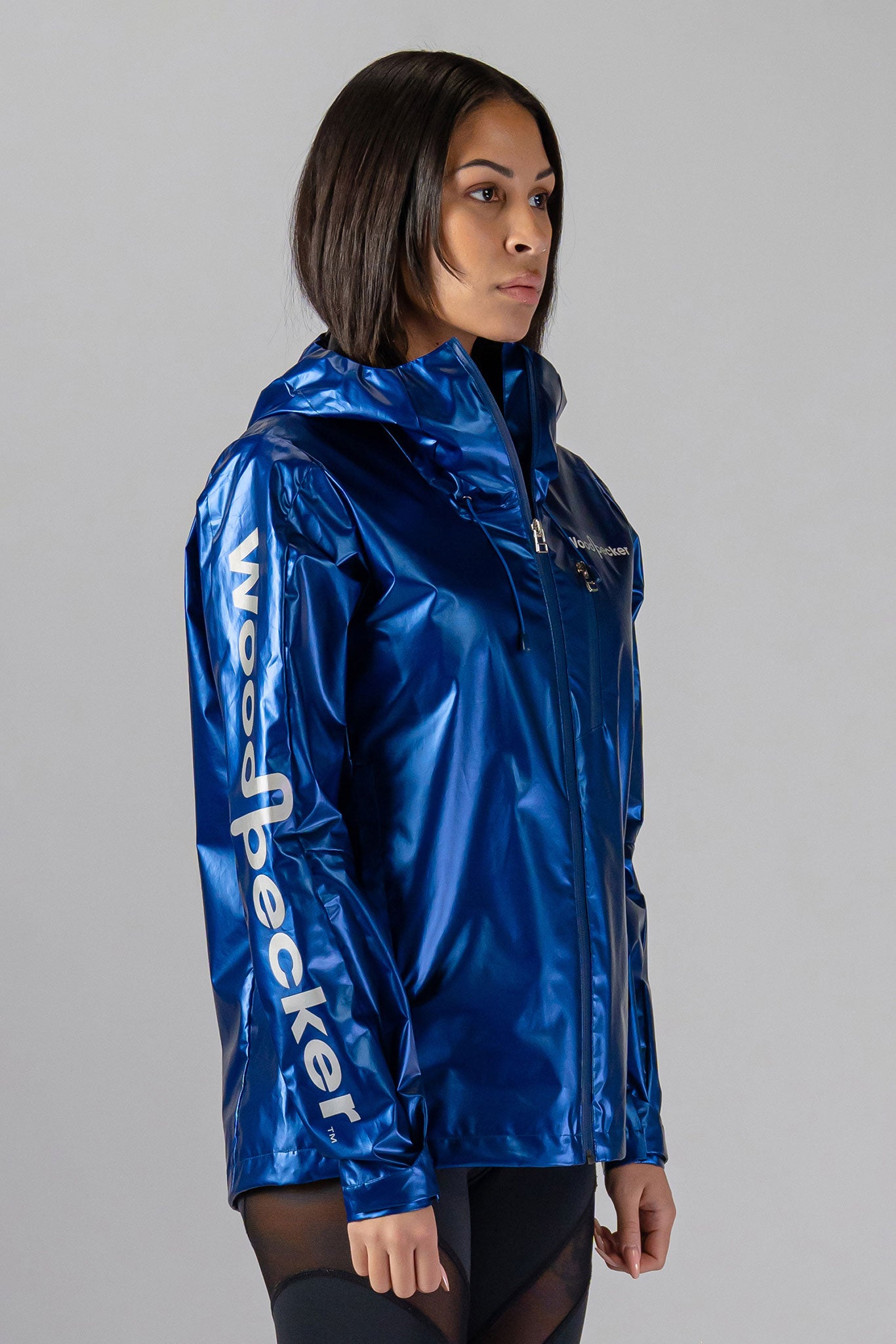 Woodpecker Women's Wind Shell coat. High-end Canadian designer activewear coat for women in "Flash Blue" colour. Woodpecker coat designed in Canada. Moose Knuckles, Canada Goose, Mackage, Montcler, Will Poho, Willbird, Nic Bayley.