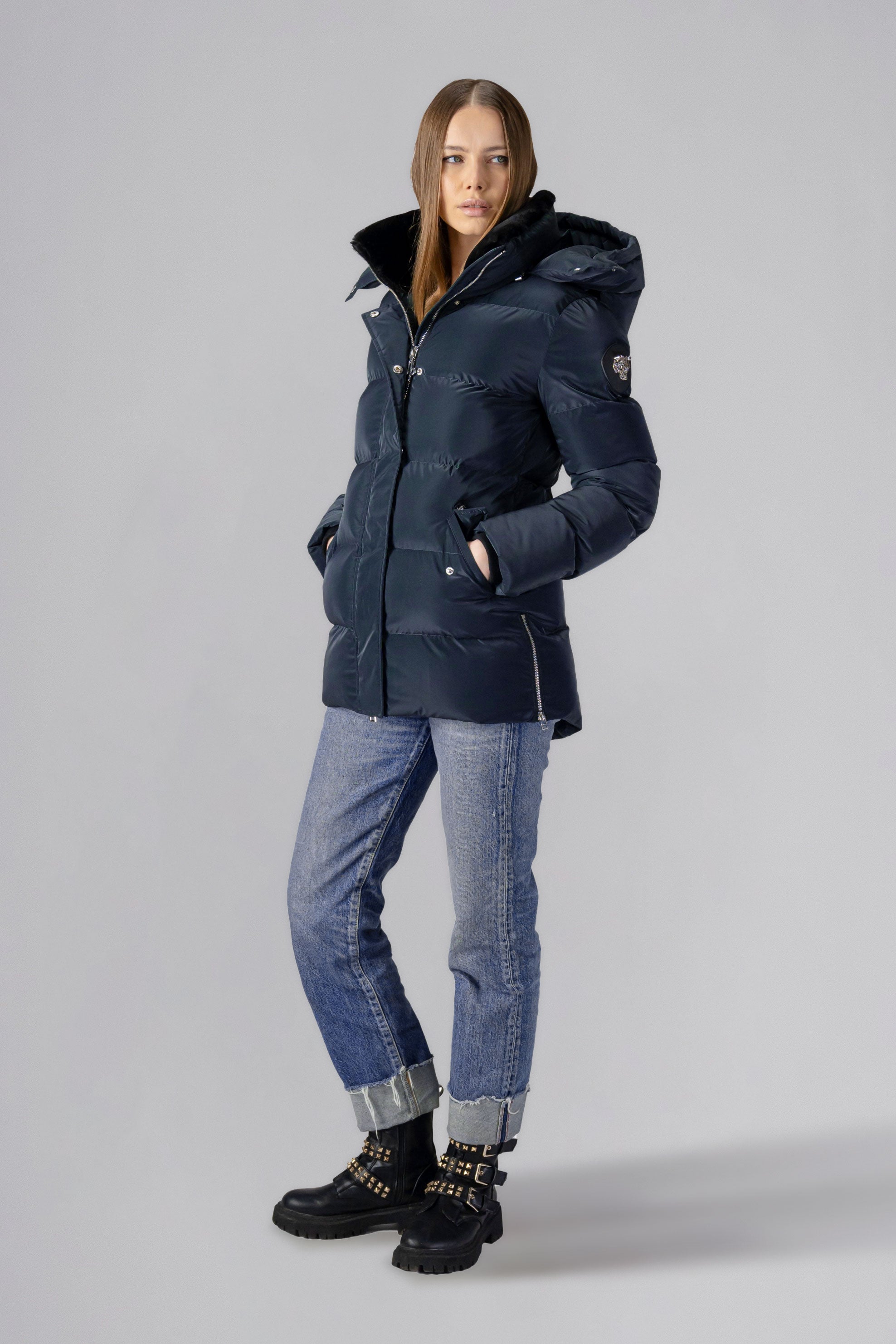 Woodpecker Women's Bumnester Winter coat. High-end Canadian designer winter coat for women in shiny "Blue Diamond" colour. Woodpecker cruelty-free winter coat designed in Canada. Women's heavy weight medium length premium designer jacket for winter. Superior quality warm winter coat for women. Moose Knuckles, Canada Goose, Mackage, Montcler, Will Poho, Willbird, Nic Bayley. Extra warm. Shiny parka. Stylish winter jacket. Designer winter coat.