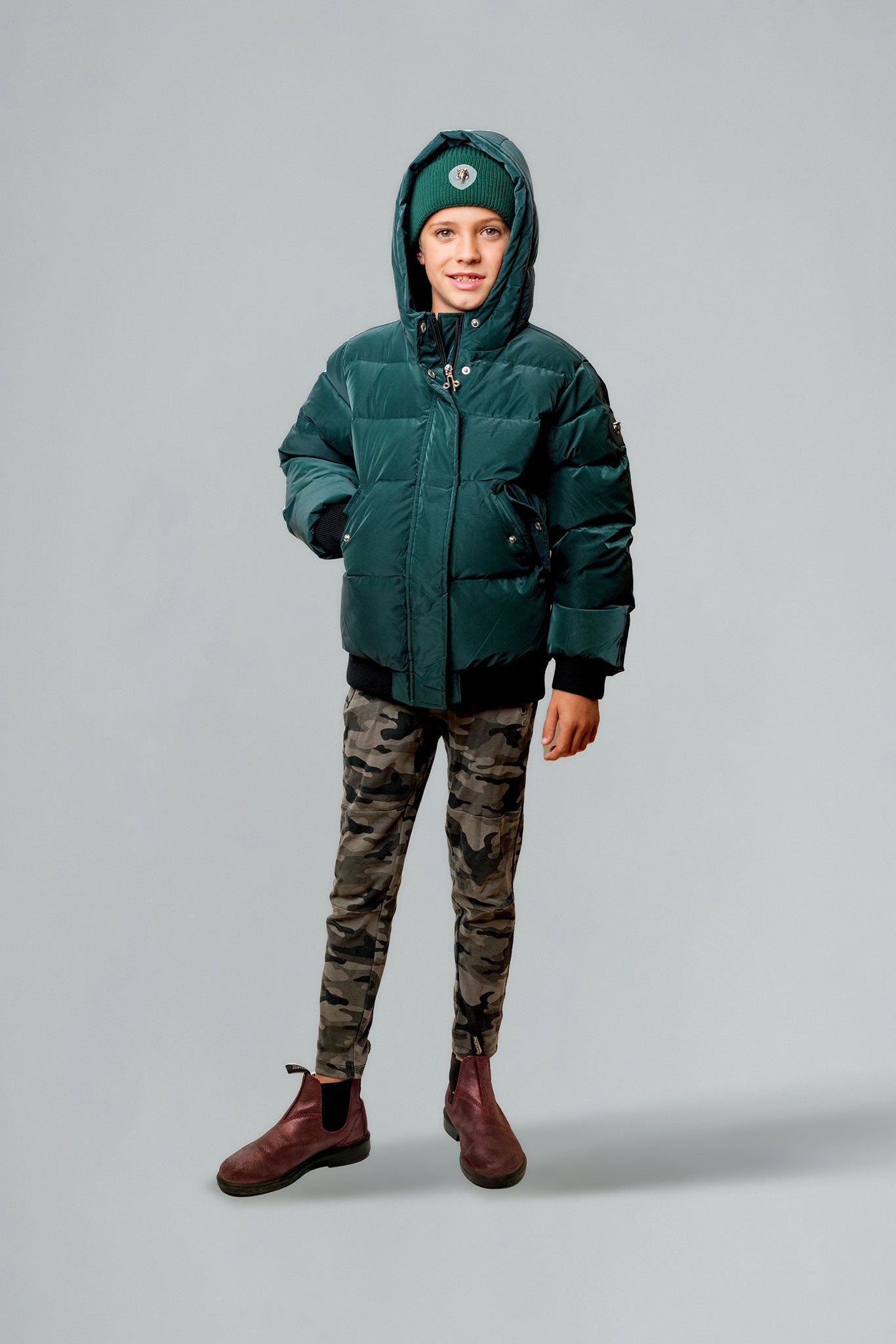 Woodpecker Kids' Chickadee Winter coat. High-end Canadian designer winter coat for Kids in "Green Diamond" colour. Woodpecker cruelty-free winter coat designed in Canada. Kids' heavy weight short length premium designer jacket for winter. Superior quality warm winter coat for kids. Moose Knuckles, Canada Goose, Mackage, Montcler, Will Poho, Willbird, Nic Bayley. Extra warm. Shiny parka. Stylish winter jacket. Designer winter coat.