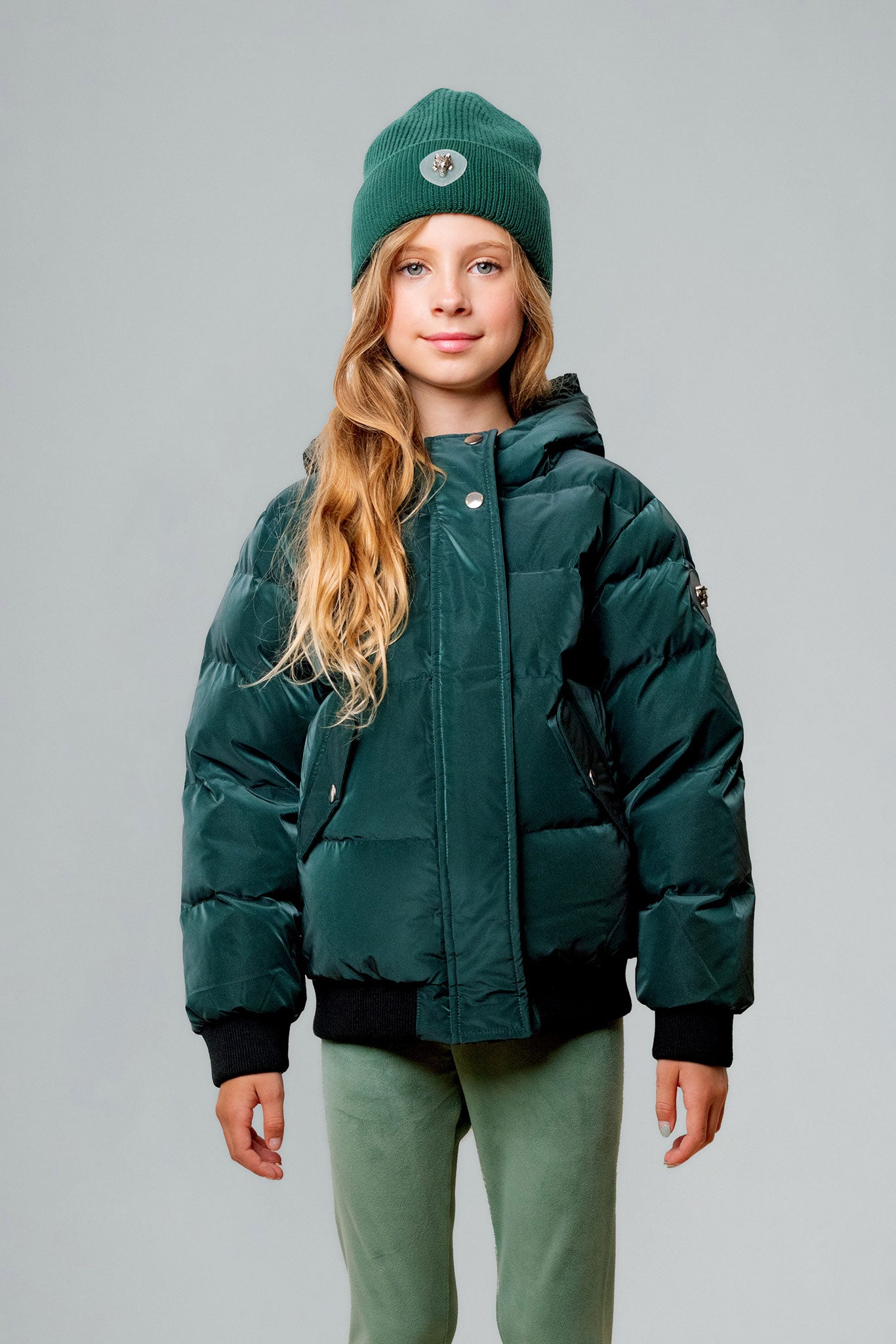 Woodpecker Kids' Chickadee Winter coat. High-end Canadian designer winter coat for Kids in "Green Diamond" colour. Woodpecker cruelty-free winter coat designed in Canada. Kids' heavy weight short length premium designer jacket for winter. Superior quality warm winter coat for kids. Moose Knuckles, Canada Goose, Mackage, Montcler, Will Poho, Willbird, Nic Bayley. Extra warm. Shiny parka. Stylish winter jacket. Designer winter coat.