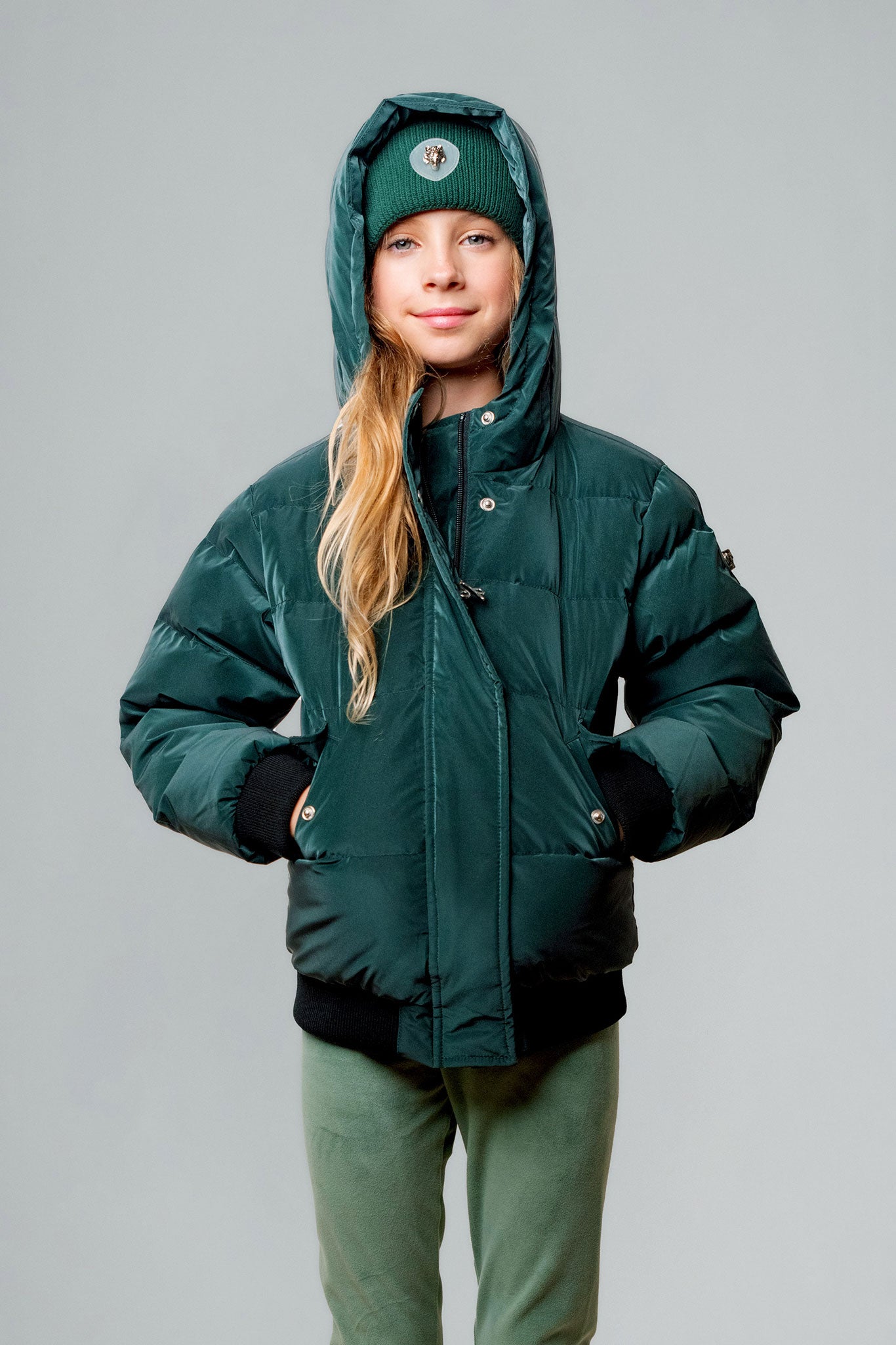 Woodpecker Kids' Chickadee Winter coat. High-end Canadian designer winter coat for Kids in "Green Diamond" colour. Woodpecker cruelty-free winter coat designed in Canada. Kids' heavy weight short length premium designer jacket for winter. Superior quality warm winter coat for kids. Moose Knuckles, Canada Goose, Mackage, Montcler, Will Poho, Willbird, Nic Bayley. Extra warm. Shiny parka. Stylish winter jacket. Designer winter coat.