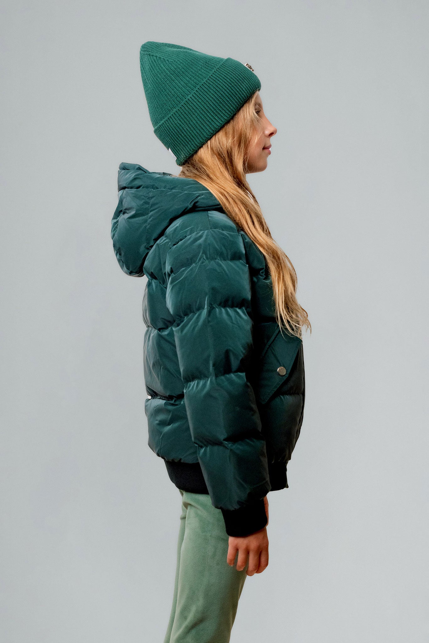 Woodpecker Kids' Chickadee Winter coat. High-end Canadian designer winter coat for Kids in "Green Diamond" colour. Woodpecker cruelty-free winter coat designed in Canada. Kids' heavy weight short length premium designer jacket for winter. Superior quality warm winter coat for kids. Moose Knuckles, Canada Goose, Mackage, Montcler, Will Poho, Willbird, Nic Bayley. Extra warm. Shiny parka. Stylish winter jacket. Designer winter coat.