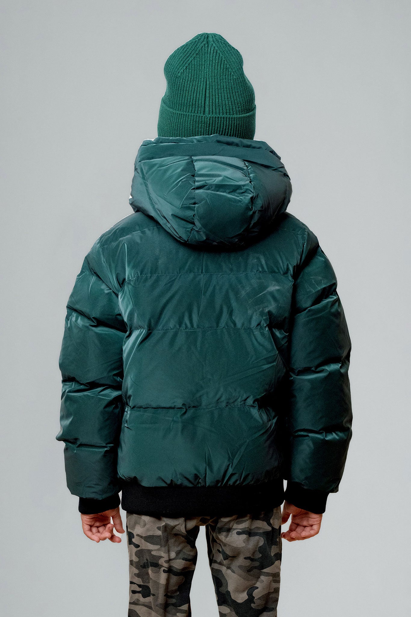 Woodpecker Kids' Chickadee Winter coat. High-end Canadian designer winter coat for Kids in "Green Diamond" colour. Woodpecker cruelty-free winter coat designed in Canada. Kids' heavy weight short length premium designer jacket for winter. Superior quality warm winter coat for kids. Moose Knuckles, Canada Goose, Mackage, Montcler, Will Poho, Willbird, Nic Bayley. Extra warm. Shiny parka. Stylish winter jacket. Designer winter coat.