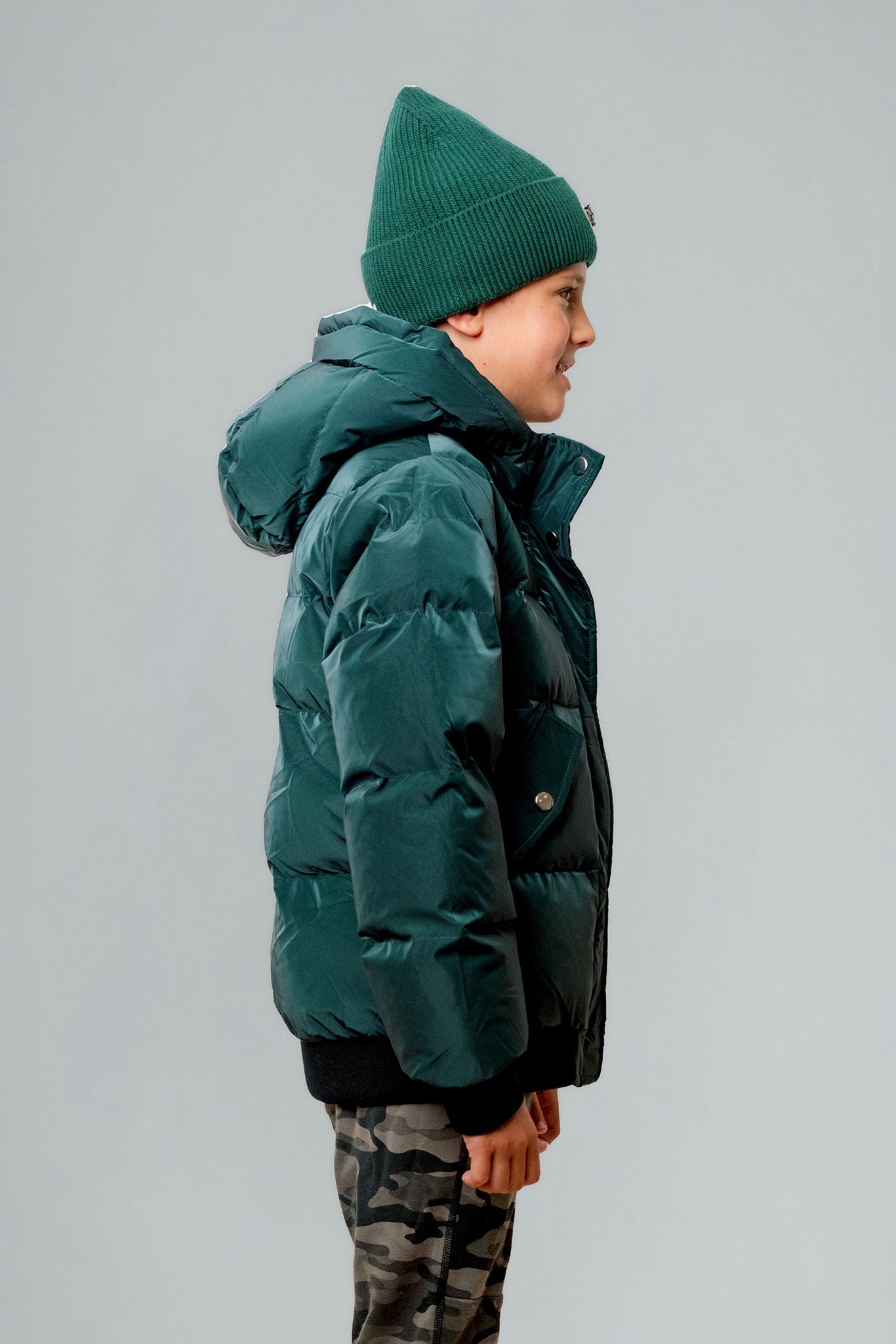 Woodpecker Kids' Chickadee Winter coat. High-end Canadian designer winter coat for Kids in "Green Diamond" colour. Woodpecker cruelty-free winter coat designed in Canada. Kids' heavy weight short length premium designer jacket for winter. Superior quality warm winter coat for kids. Moose Knuckles, Canada Goose, Mackage, Montcler, Will Poho, Willbird, Nic Bayley. Extra warm. Shiny parka. Stylish winter jacket. Designer winter coat.