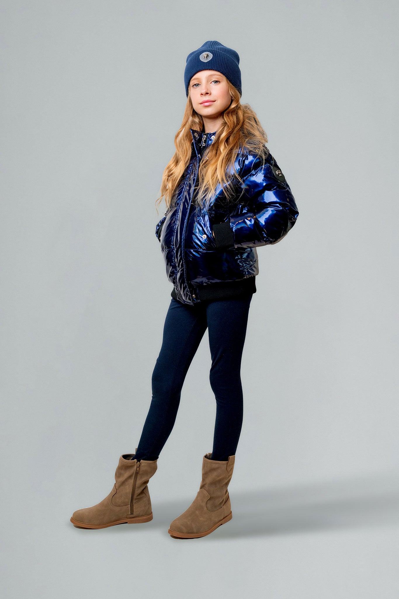 Woodpecker Kids' Chickadee Winter coat. High-end Canadian designer winter coat for Kids in "Oily Blue" colour. Woodpecker cruelty-free winter coat designed in Canada. Kids' heavy weight short length premium designer jacket for winter. Superior quality warm winter coat for kids. Moose Knuckles, Canada Goose, Mackage, Montcler, Will Poho, Willbird, Nic Bayley. Extra warm. Shiny parka. Stylish winter jacket. Designer winter coat.