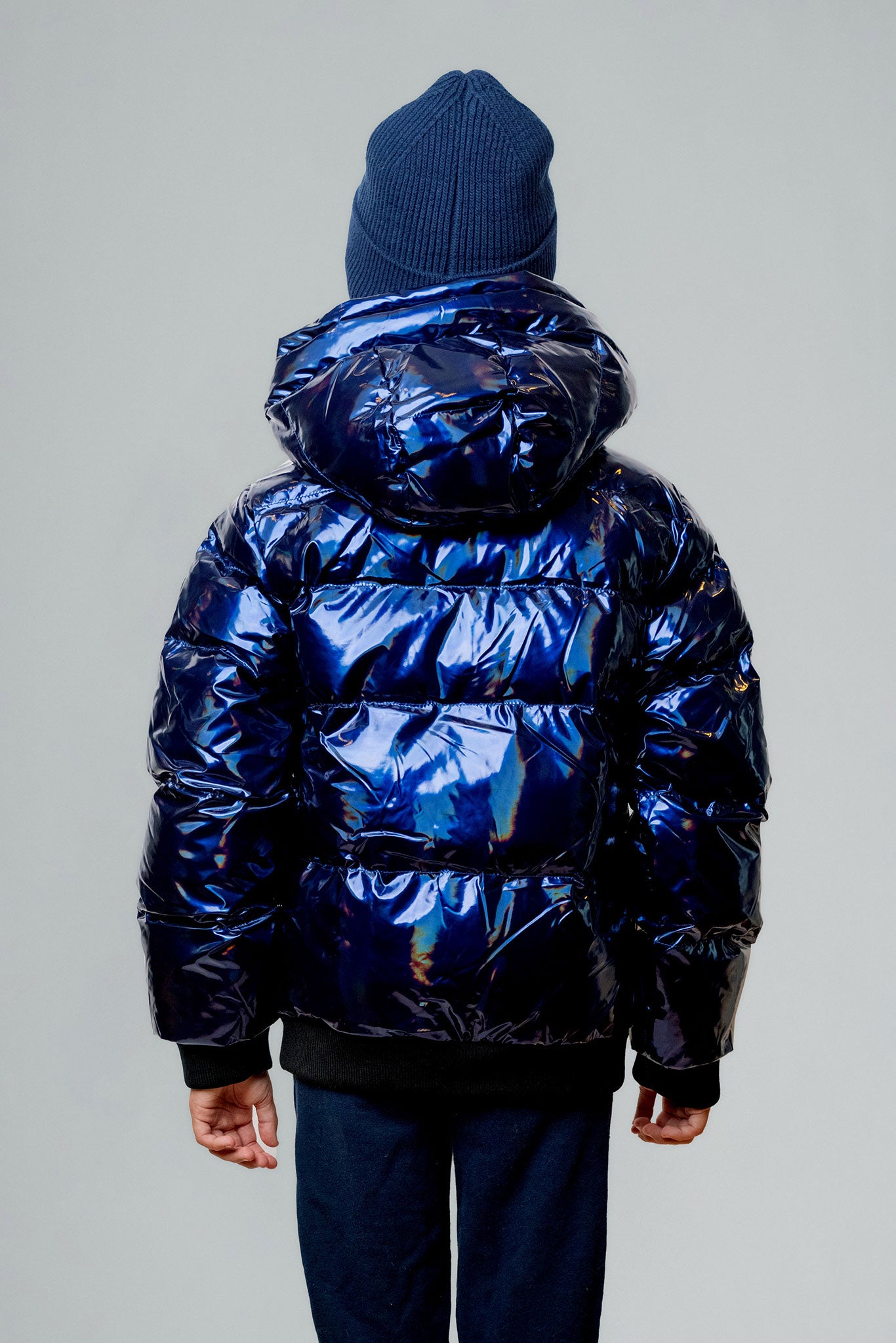 Woodpecker Kids' Chickadee Winter coat. High-end Canadian designer winter coat for Kids in "Oily Blue" colour. Woodpecker cruelty-free winter coat designed in Canada. Kids' heavy weight short length premium designer jacket for winter. Superior quality warm winter coat for kids. Moose Knuckles, Canada Goose, Mackage, Montcler, Will Poho, Willbird, Nic Bayley. Extra warm. Shiny parka. Stylish winter jacket. Designer winter coat.