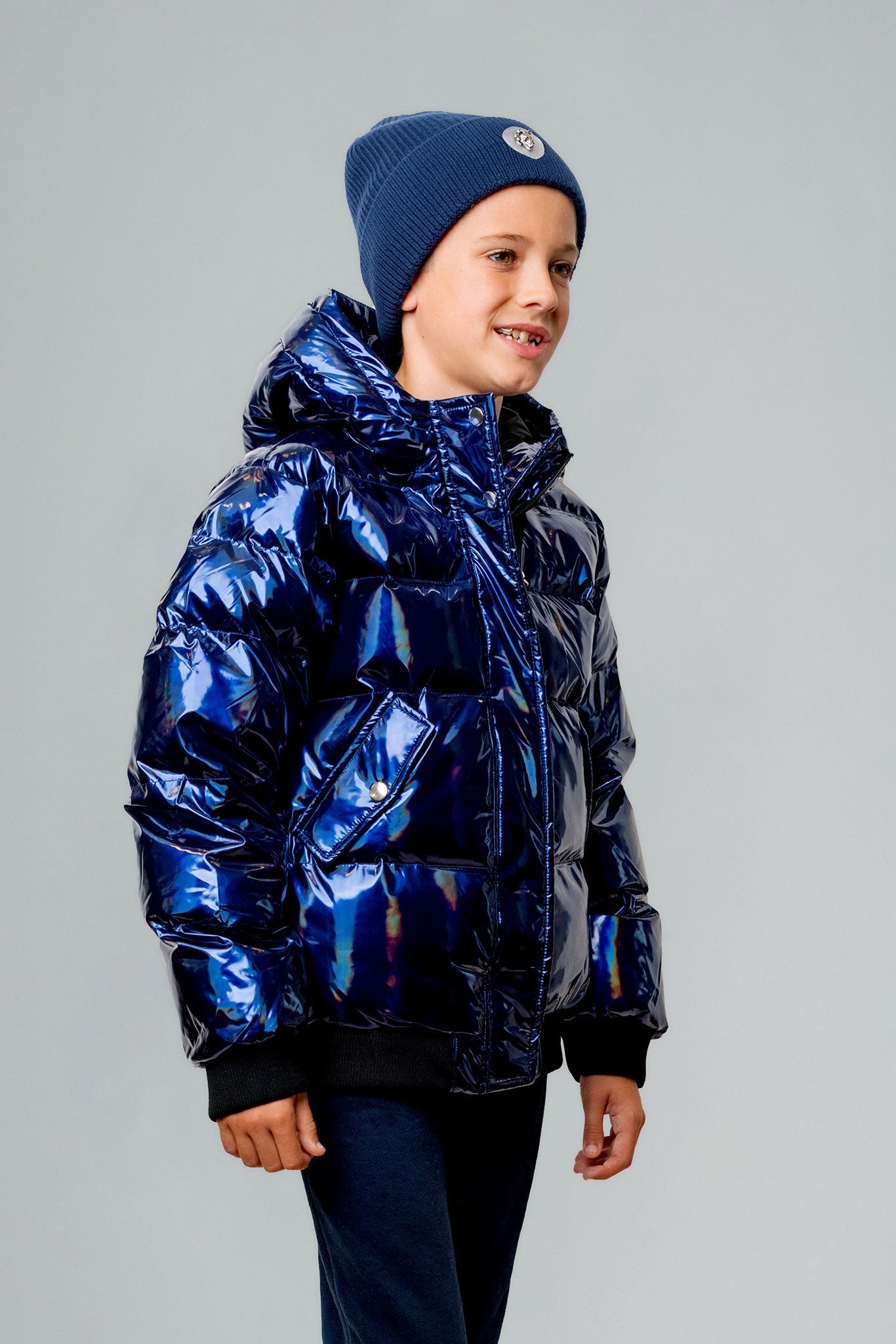 Woodpecker Kids' Chickadee Winter coat. High-end Canadian designer winter coat for Kids in "Oily Blue" colour. Woodpecker cruelty-free winter coat designed in Canada. Kids' heavy weight short length premium designer jacket for winter. Superior quality warm winter coat for kids. Moose Knuckles, Canada Goose, Mackage, Montcler, Will Poho, Willbird, Nic Bayley. Extra warm. Shiny parka. Stylish winter jacket. Designer winter coat.