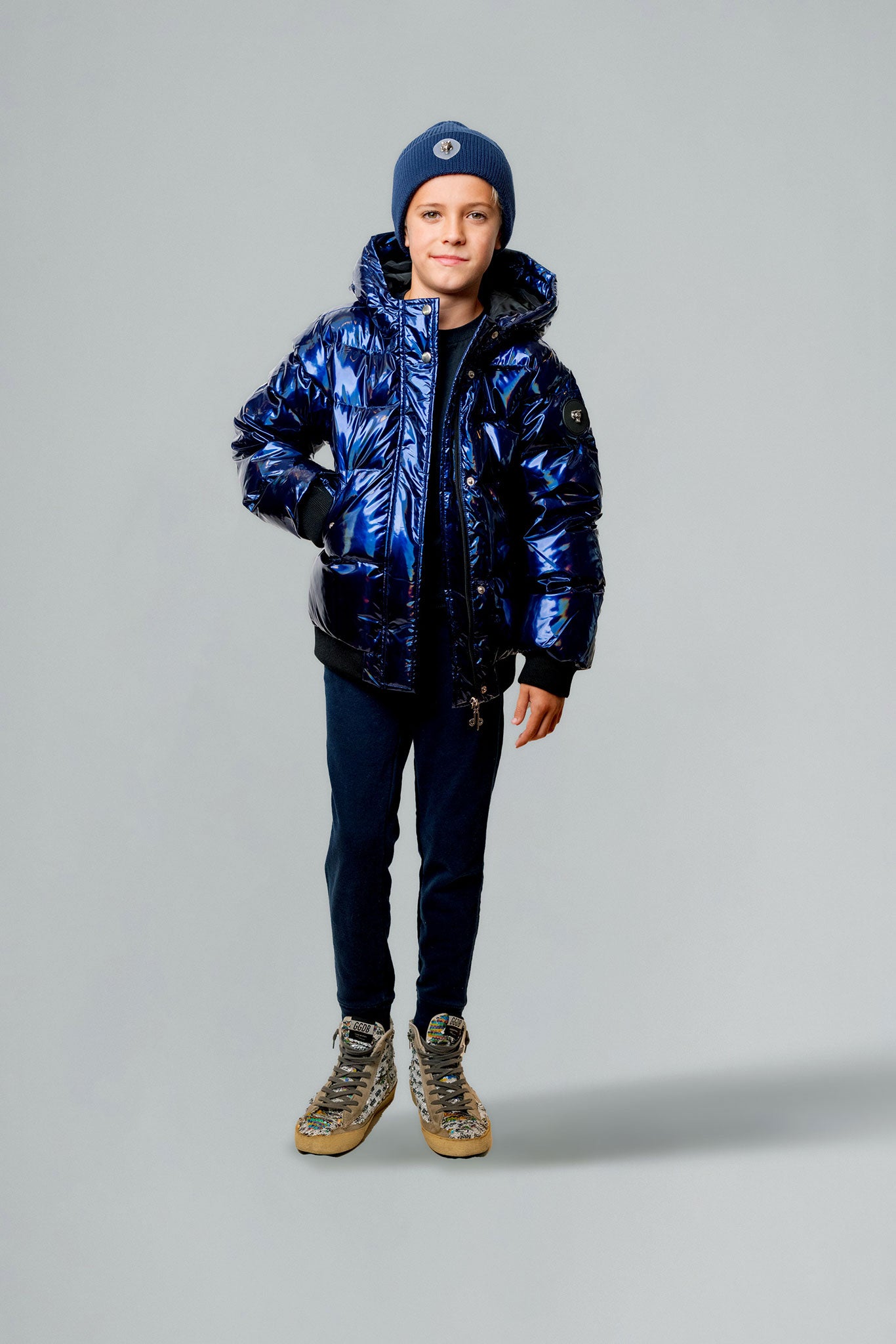 Woodpecker Kids' Chickadee Winter coat. High-end Canadian designer winter coat for Kids in "Oily Blue" colour. Woodpecker cruelty-free winter coat designed in Canada. Kids' heavy weight short length premium designer jacket for winter. Superior quality warm winter coat for kids. Moose Knuckles, Canada Goose, Mackage, Montcler, Will Poho, Willbird, Nic Bayley. Extra warm. Shiny parka. Stylish winter jacket. Designer winter coat.