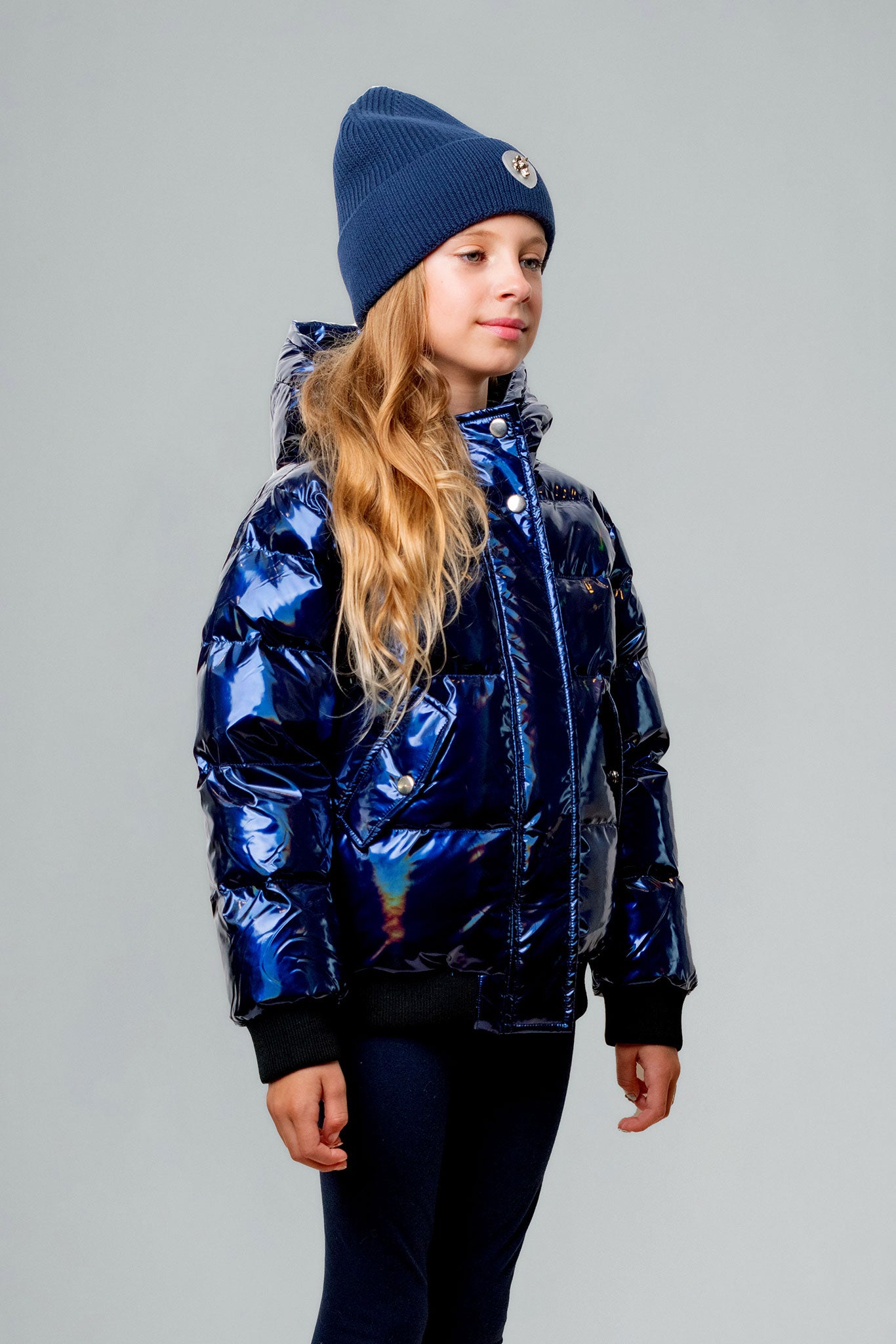 Woodpecker Kids' Chickadee Winter coat. High-end Canadian designer winter coat for Kids in "Oily Blue" colour. Woodpecker cruelty-free winter coat designed in Canada. Kids' heavy weight short length premium designer jacket for winter. Superior quality warm winter coat for kids. Moose Knuckles, Canada Goose, Mackage, Montcler, Will Poho, Willbird, Nic Bayley. Extra warm. Shiny parka. Stylish winter jacket. Designer winter coat.