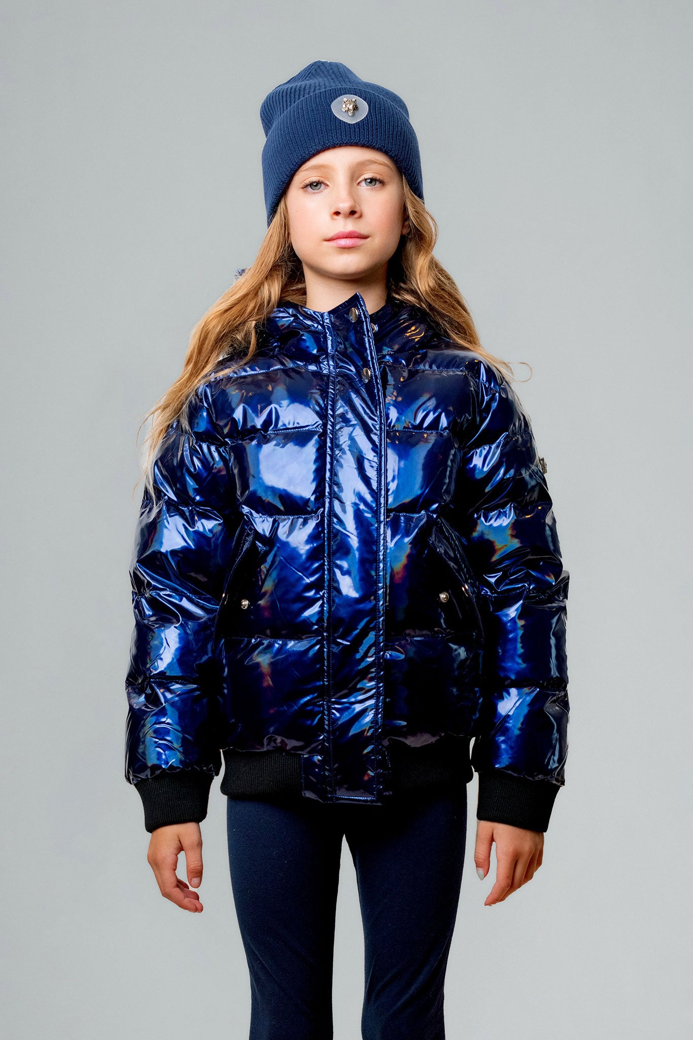 Woodpecker Kids' Chickadee Winter coat. High-end Canadian designer winter coat for Kids in "Oily Blue" colour. Woodpecker cruelty-free winter coat designed in Canada. Kids' heavy weight short length premium designer jacket for winter. Superior quality warm winter coat for kids. Moose Knuckles, Canada Goose, Mackage, Montcler, Will Poho, Willbird, Nic Bayley. Extra warm. Shiny parka. Stylish winter jacket. Designer winter coat.