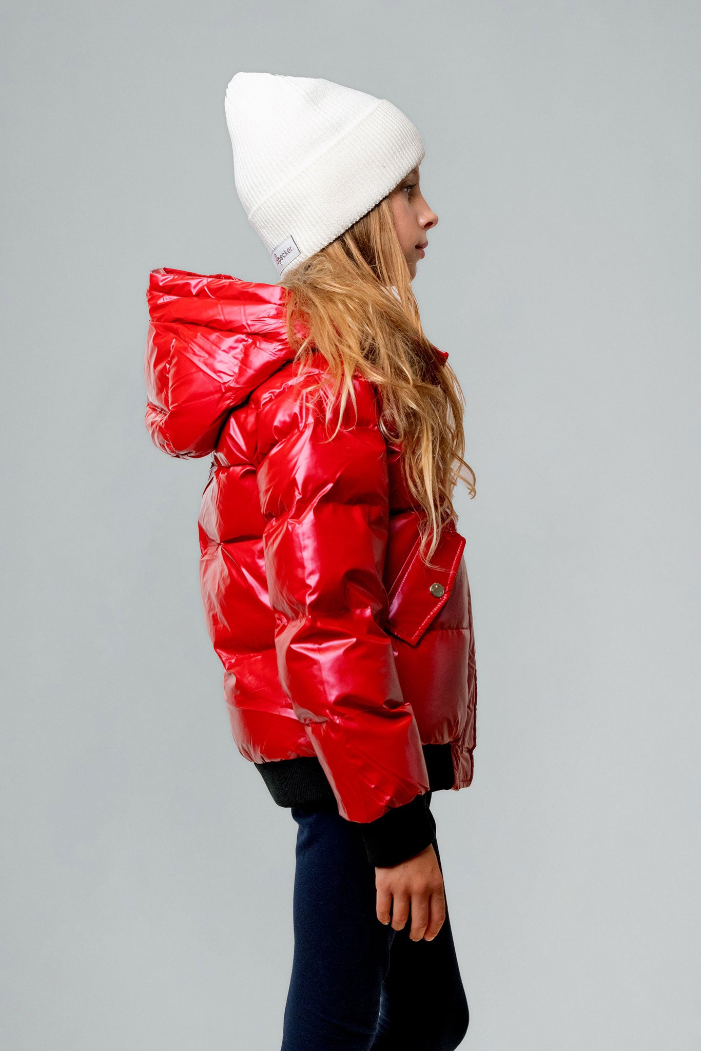 Woodpecker Kids' Chickadee Winter coat. High-end Canadian designer winter coat for Kids in "Raspberry" colour. Woodpecker cruelty-free winter coat designed in Canada. Kids' heavy weight short length premium designer jacket for winter. Superior quality warm winter coat for kids. Moose Knuckles, Canada Goose, Mackage, Montcler, Will Poho, Willbird, Nic Bayley. Extra warm. Shiny parka. Stylish winter jacket. Designer winter coat.